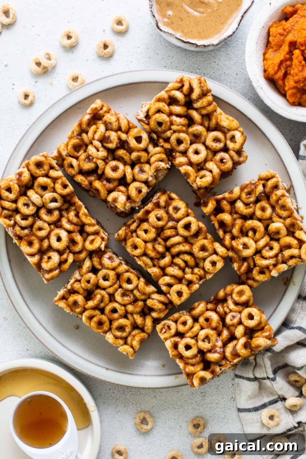 Pumpkin PB Cereal Bars 2 A plate with a plate of cereal bars and a bowl of peanut butter.