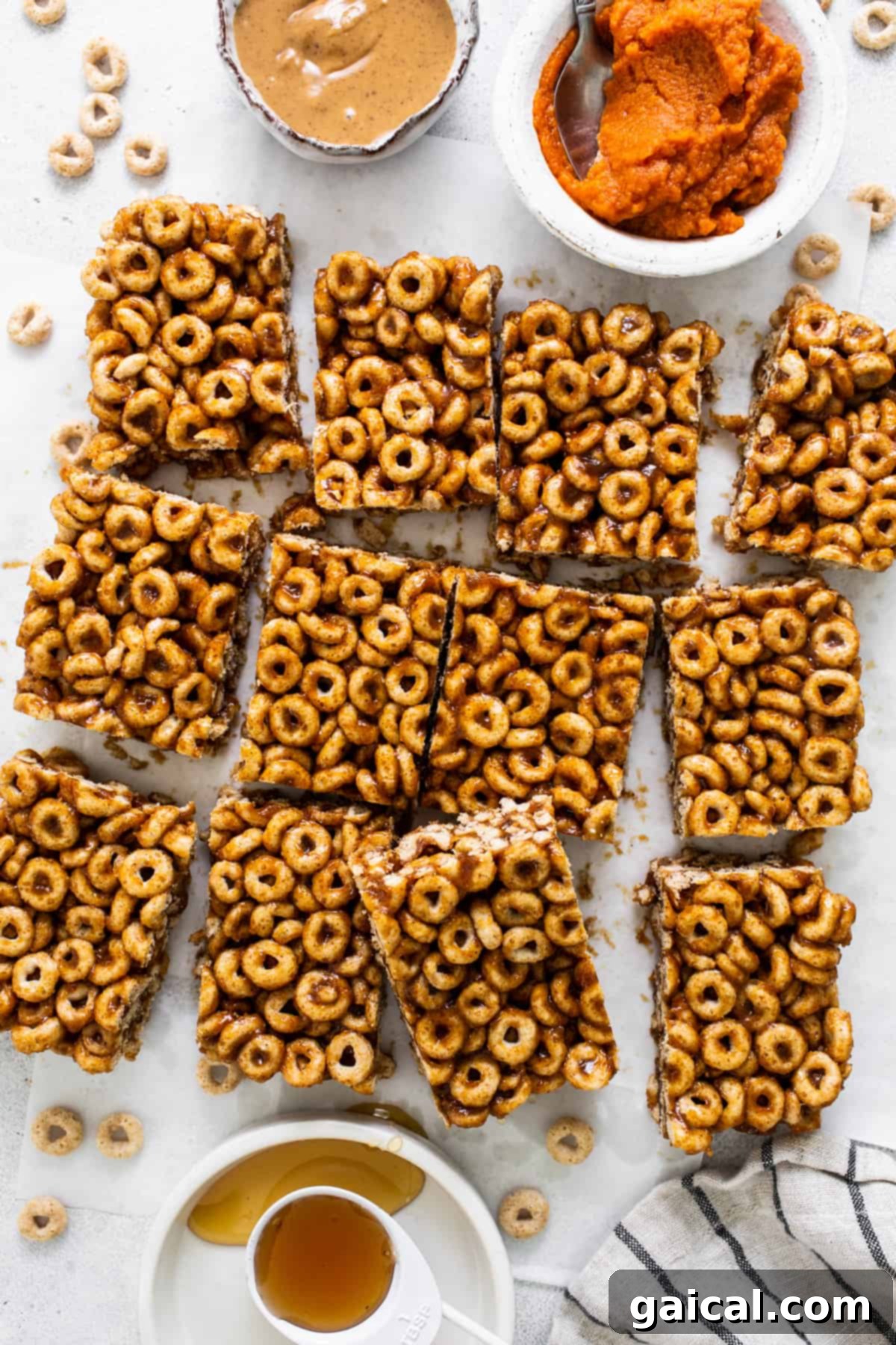 Pumpkin PB Cereal Bars 7 A plate of granola bars with a bowl of peanut butter.