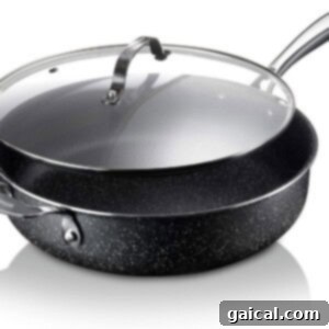 A black, deep oven-safe pot with a lid on a white background, ideal for one-pot meals.
