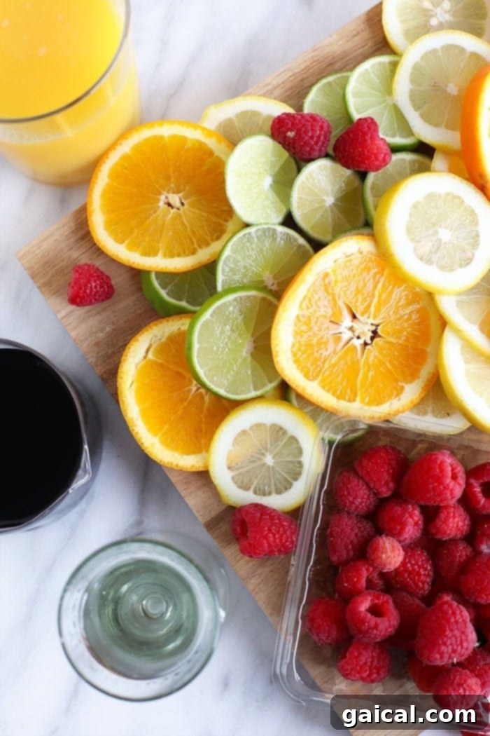 Best Fruits for Homemade Sangria Assortment of fresh fruits ideal for sangria, including oranges, lemons, limes, and berries, arranged beautifully.