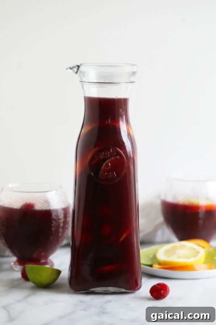 Chilling Red Wine Sangria Close-up of a glass bottle filled with rich red wine sangria and fruit slices, chilling for infusion.