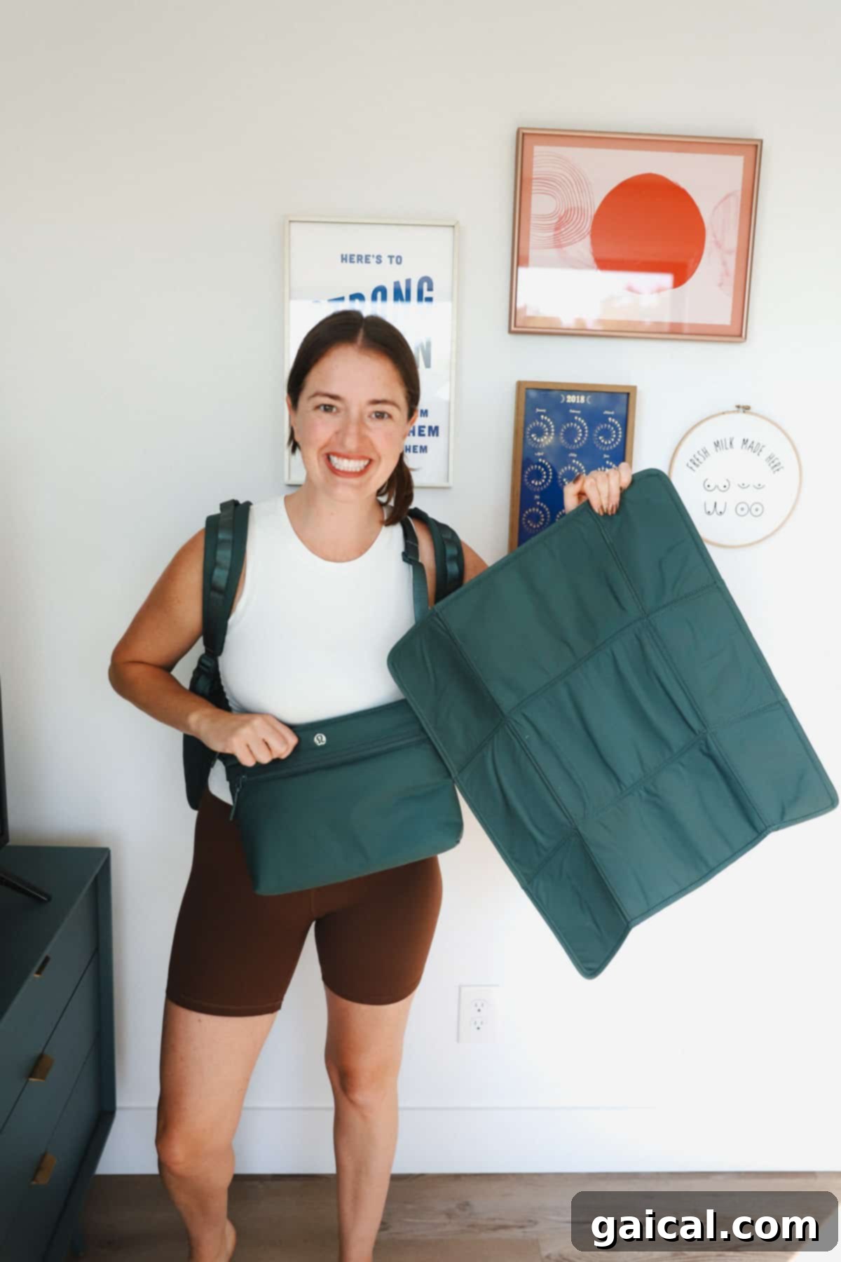 Lululemon Modern Parent Carryall 5 A parent holding the Lululemon New Parent Backpack in green, demonstrating its practical size and how easily it blends into daily life as a stylish and functional accessory.