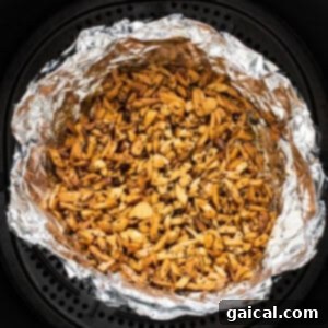 An air fryer filled with nuts.