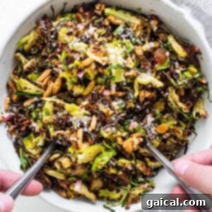 Brussels sprouts salad in a bowl with two forks.