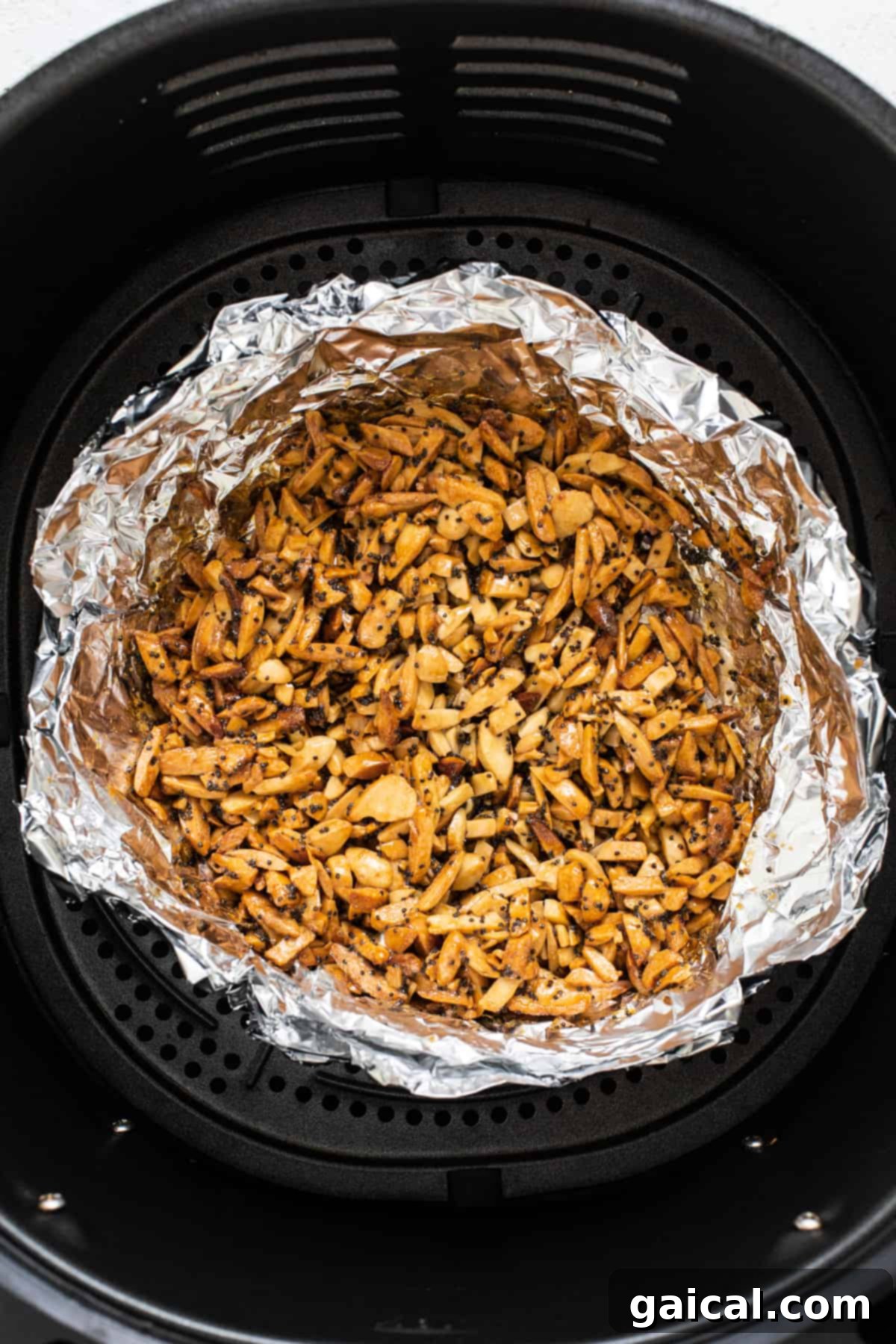 An air fryer filled with nuts.