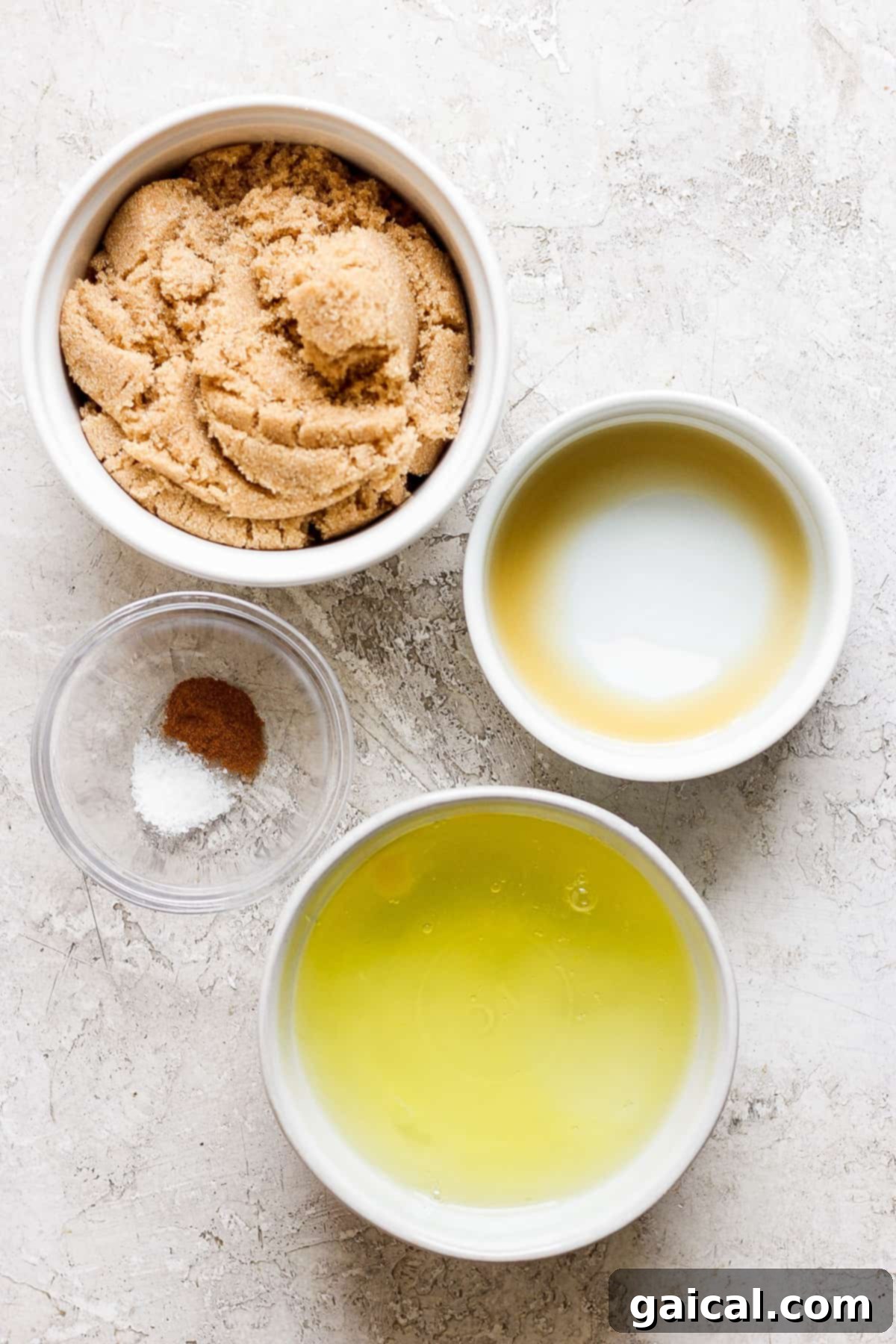 A bowl of light brown sugar, vanilla extract, ground cinnamon, and sea salt, ingredients for the Swiss meringue.