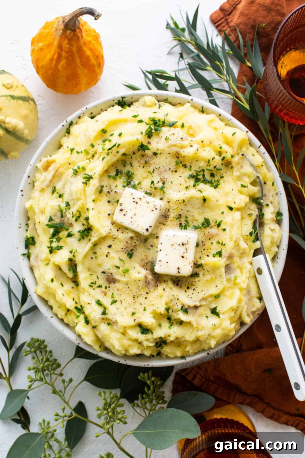 A beautifully presented bowl of fluffy whipped cottage cheese mashed potatoes, garnished with fresh herbs and a hint of feta cheese.