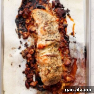 A beautifully roasted turkey roulade on a baking sheet, golden brown and perfectly cooked.