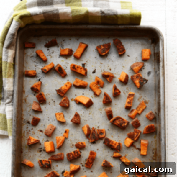 Sweet potato cubes on a baking sheet.