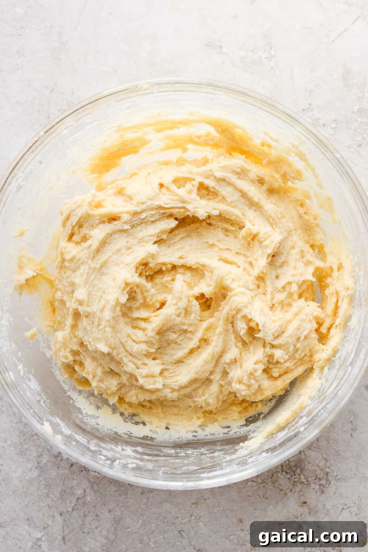 A bowl of creamy ricotta cheese, highlighted as the secret ingredient for moist cookies.