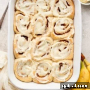 Nutty Brown Butter Banana Bread Cinnamon Rolls 14 A dish of freshly baked brown butter banana bread cinnamon rolls, beautifully frosted and ready to be served.
