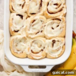 Cinnamon rolls in a baking dish with bananas.