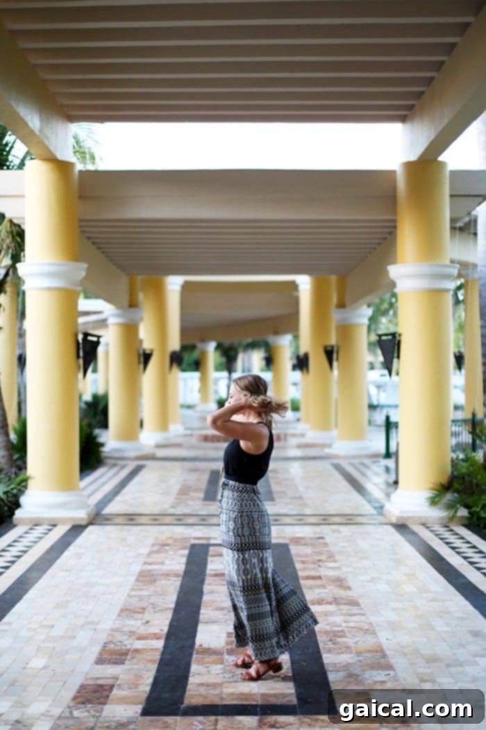 A guest enjoying a moment of relaxation on a sun lounger by the pool at Iberostar Grand Hotel Paraíso.