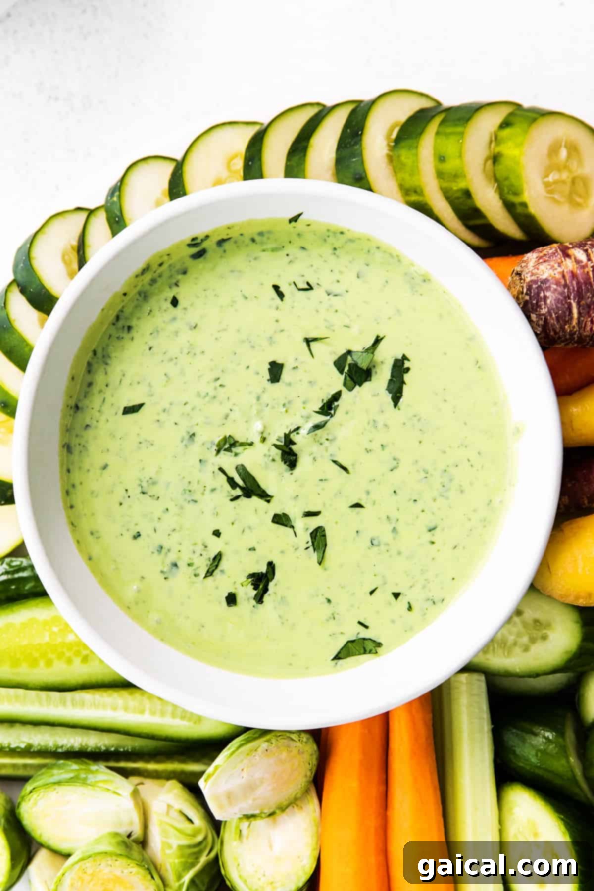 The Most Perfect All-Purpose Creamy Green Goddess Dressing & Dip Green Goddess dressing in a serving bowl, showcasing its vibrant green color and creamy texture.
