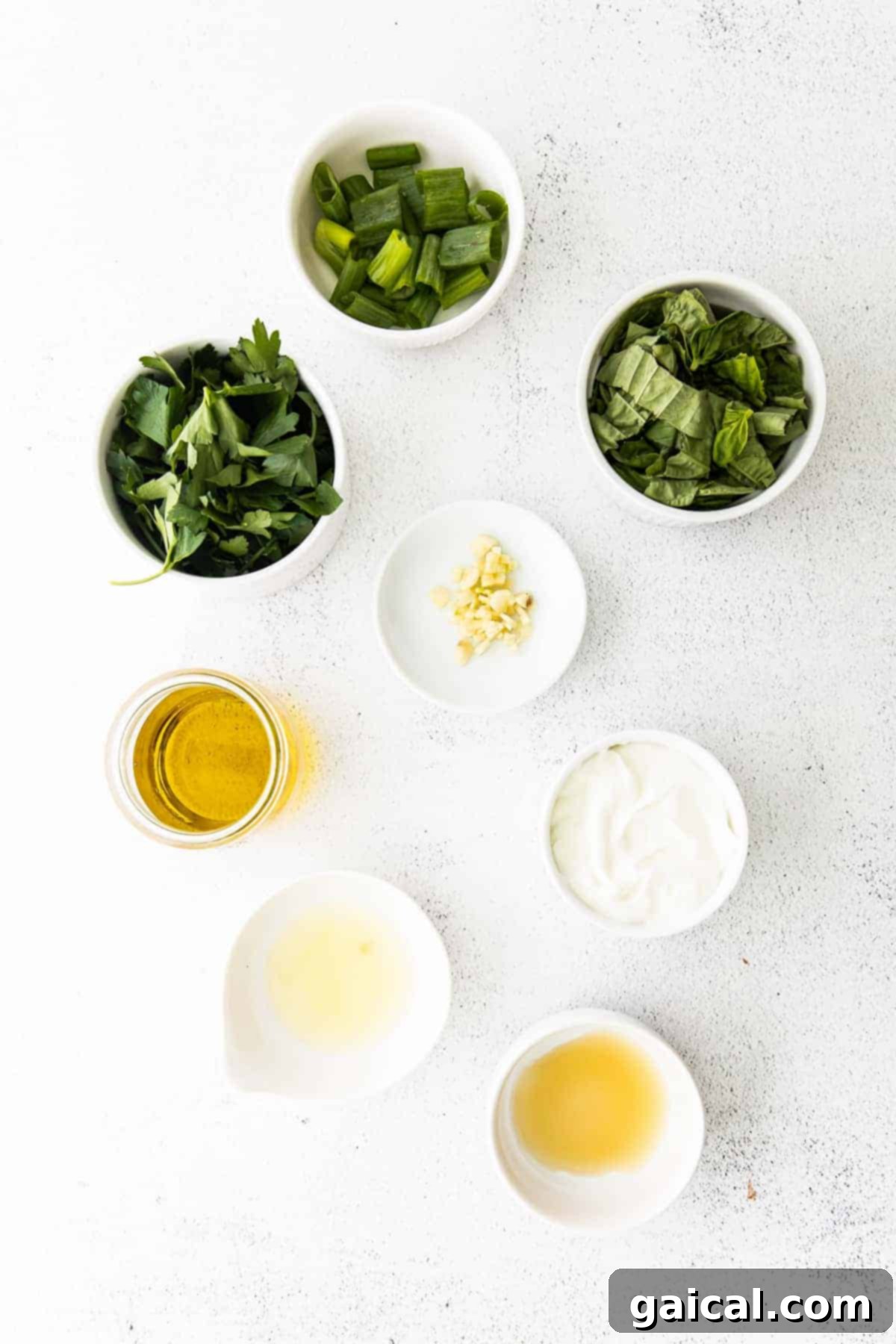 Healthy Green Goddess Dressing with Anti-Inflammatory Ingredients Green Goddess dressing in a bowl on a light-colored countertop, ready to be served.