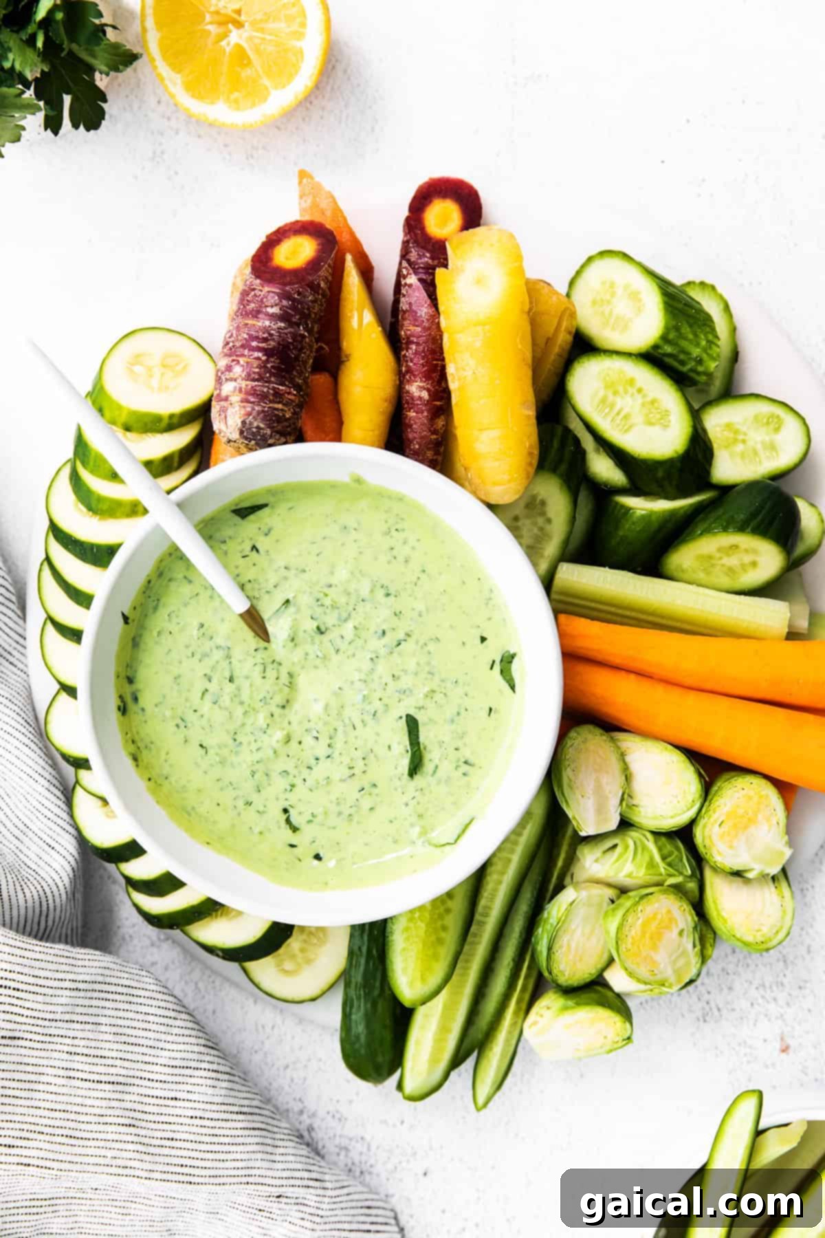 Green Goddess Dressing in a Bowl for Serving or Storage A bowl of Green Goddess dressing on a wooden surface, ready for serving or storage.