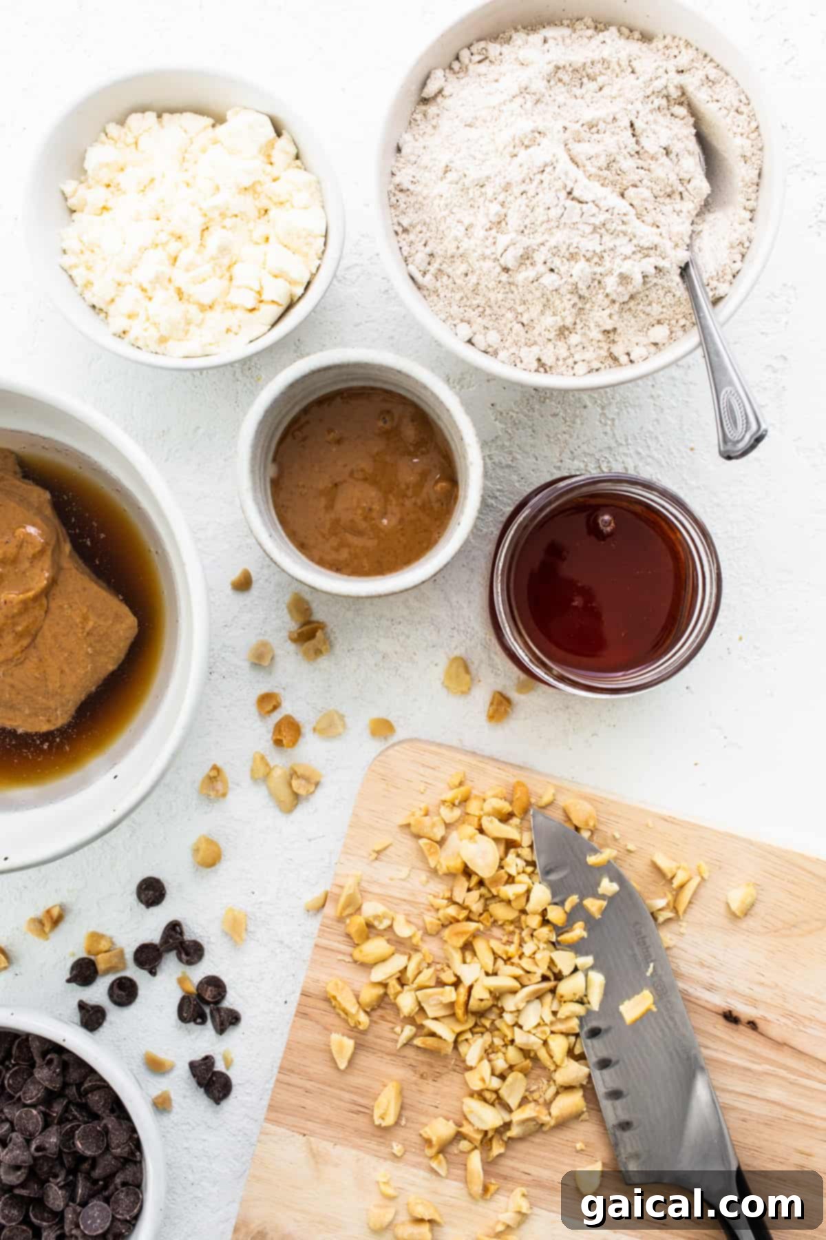 A vibrant display of fresh, wholesome ingredients arranged for making healthy peanut butter protein bars on a rustic wooden cutting board.