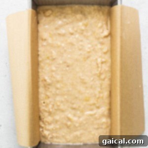 Banana bread batter in a loaf pan, ready for baking.