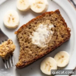 A slice of banana bread on a plate with a fork.