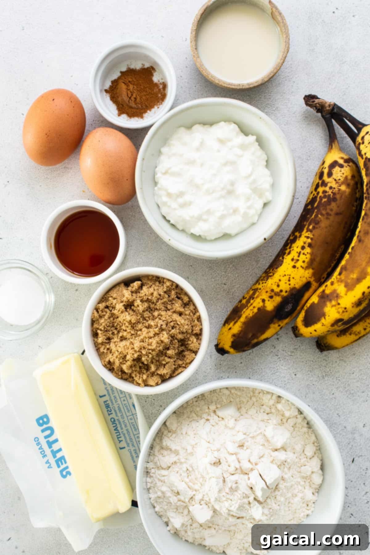 Protein-Boosted Banana Bread 3 Ingredients for protein banana bread laid out, including ripe bananas, flour, eggs, and butter.