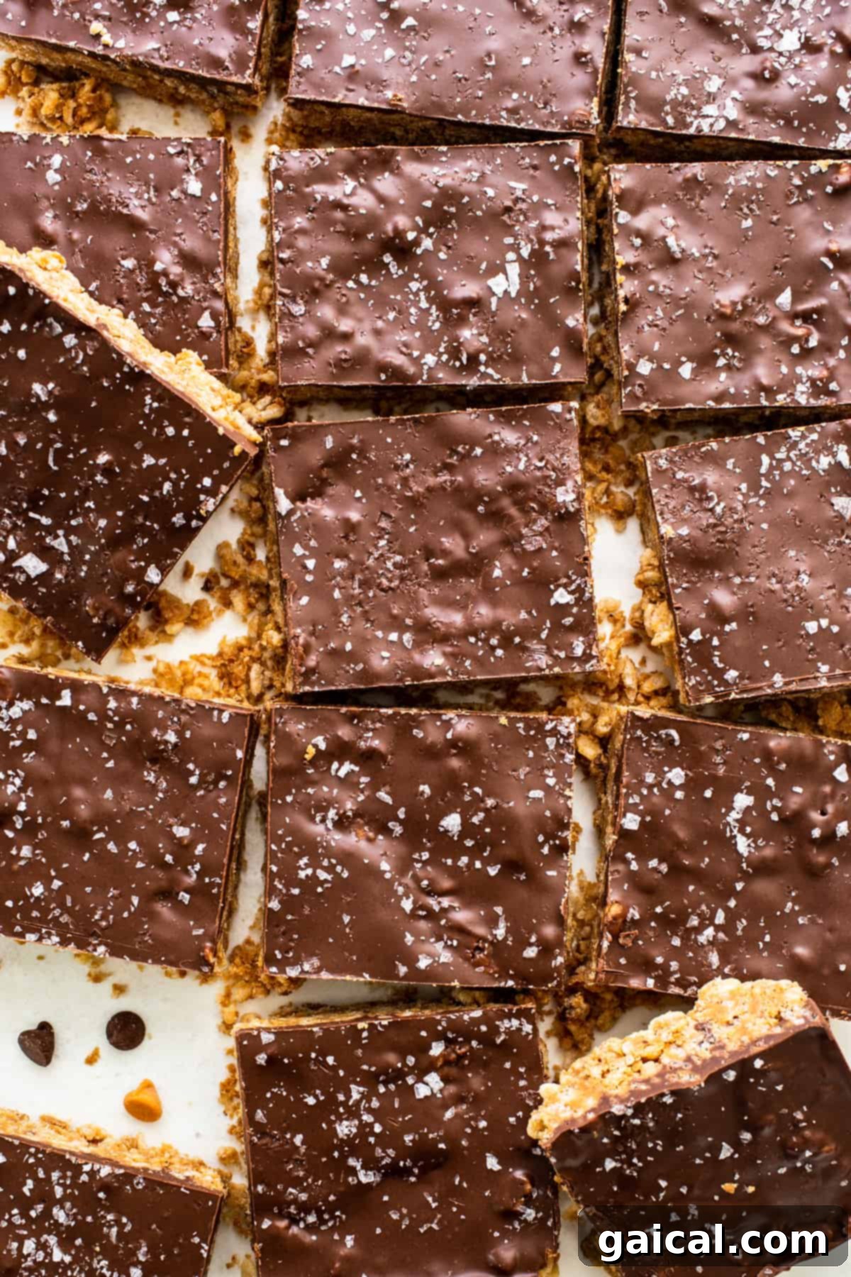 Protein-Powered Peanut Butter Chocolate Crisps 2 A sheet of chocolate peanut butter protein bars on a white plate, cut into perfect squares.