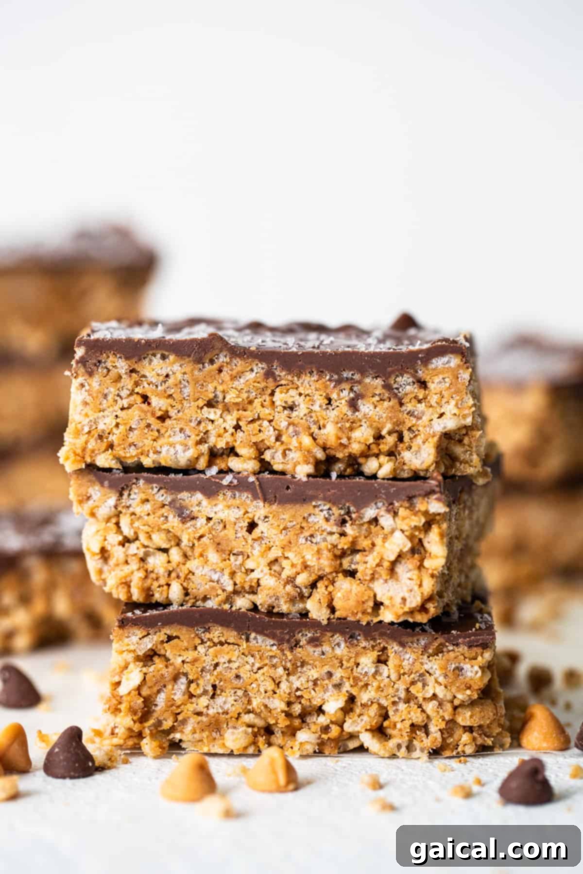 Protein-Powered Peanut Butter Chocolate Crisps 8 A neatly stacked pile of chocolate peanut butter granola bars, showcasing their inviting texture.