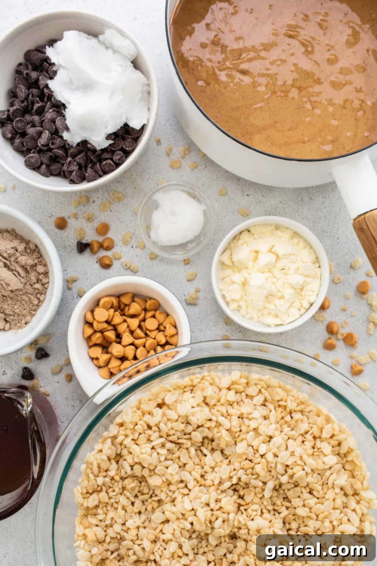 Protein-Powered Peanut Butter Chocolate Crisps 3 Bowls of key ingredients like oats, chocolate chips, and peanut butter neatly arranged on a white background, ready for preparation.