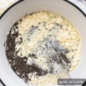 Dreamy Protein Coconut Cream Pie Chia Pudding 8 A bowl of ingredients in a pan with a wooden spoon, symbolizing the initial mixing stage of the chia pudding.