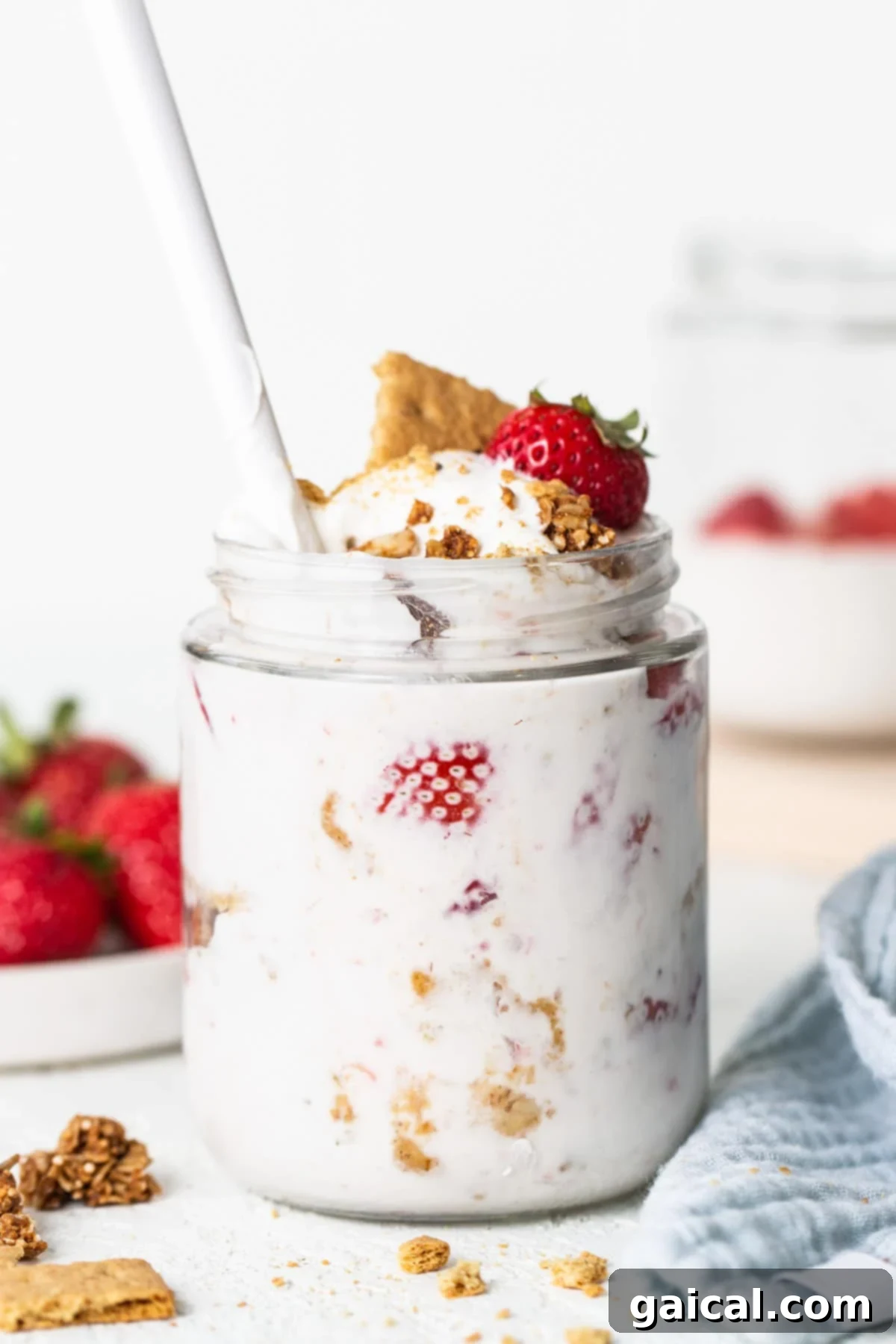 Creamy Protein Strawberry Cheesecake Jars 5 A jar of yogurt with strawberries and granola.