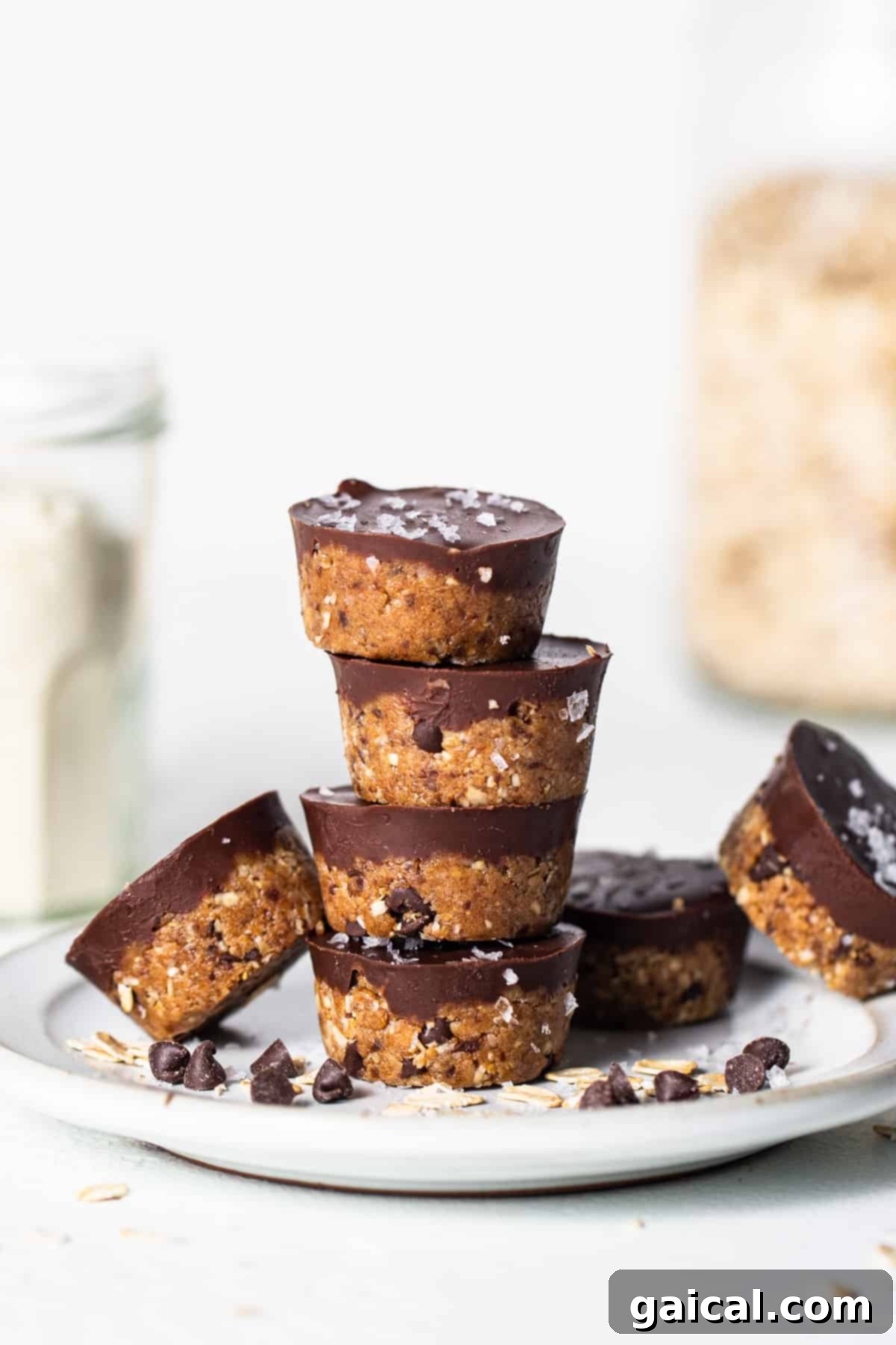 Healthy Protein Cookie Dough Bites 2 A stack of chocolate oatmeal cups on a plate, showcasing their delightful texture and chocolate topping.