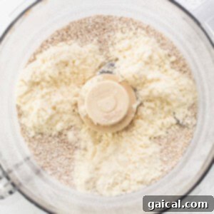 A food processor filled with flour and other ingredients.