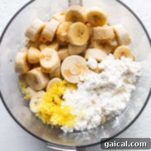 Sunshine Lemon Cheesecake Nice Cream 9 A bowl showing sliced frozen bananas and cottage cheese, ready for blending.