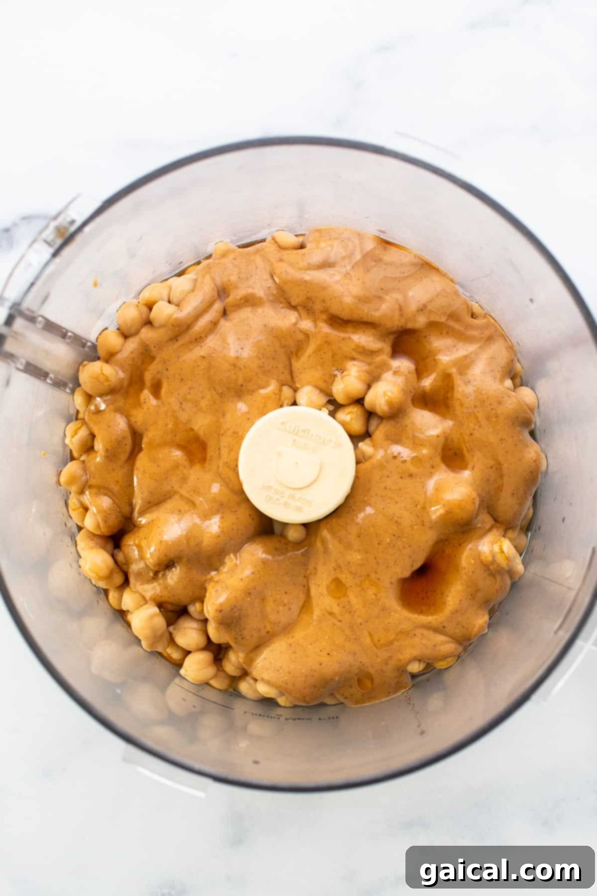 Epic Protein Cookie Dough 3 Smooth and creamy peanut butter being processed in a food processor, a key step for this cookie dough.