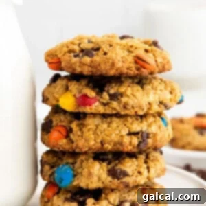 Epic Protein Cookie Dough 5 A stack of delicious flourless monster cookies, packed with oats, peanut butter, chocolate chips, and M&Ms.