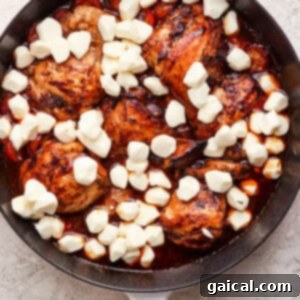 A pan with chicken and cheese in it.