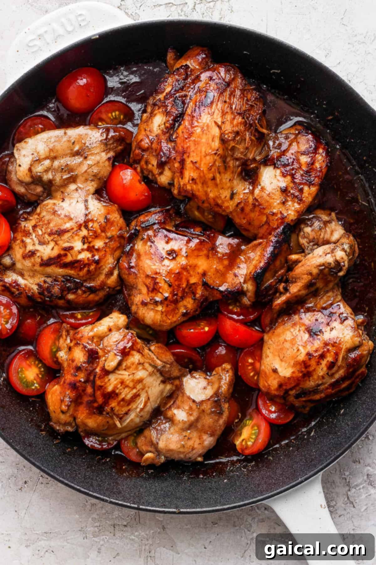 Rich Balsamic Glazed Chicken Thighs 5 Grilled chicken in a skillet with tomatoes.