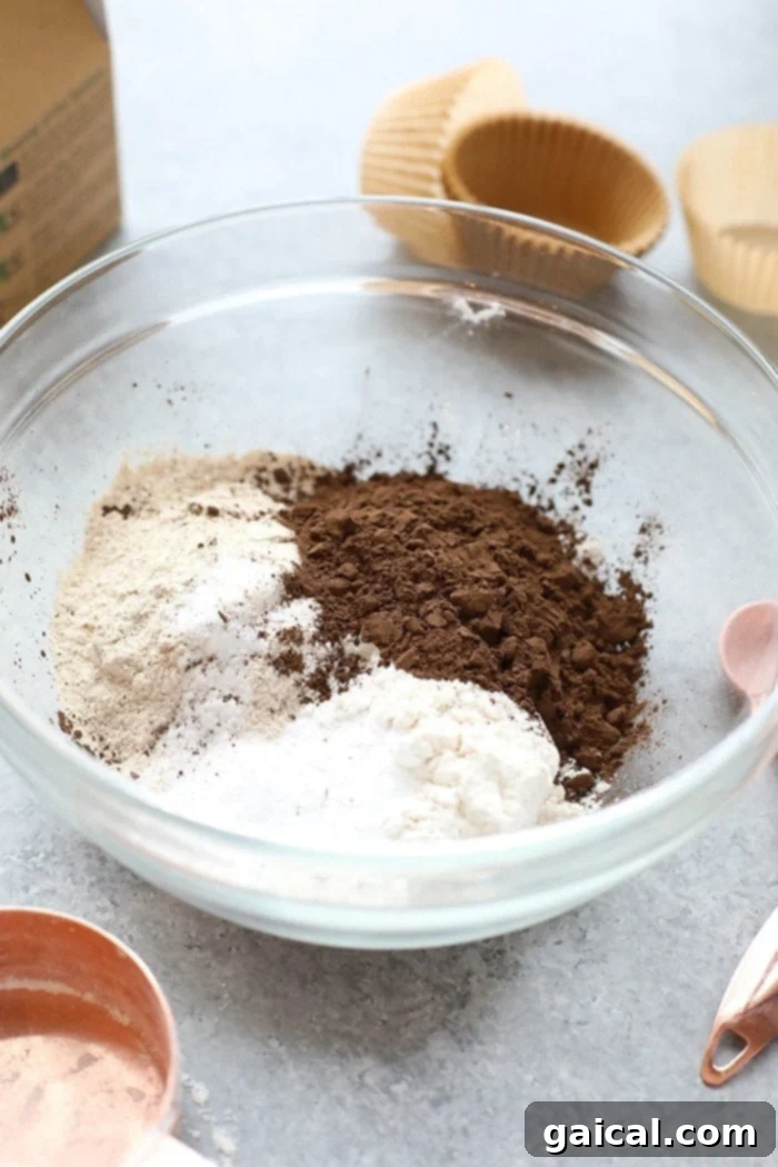 Ingredients for healthier chocolate cupcakes laid out in a bowl, ready for mixing
