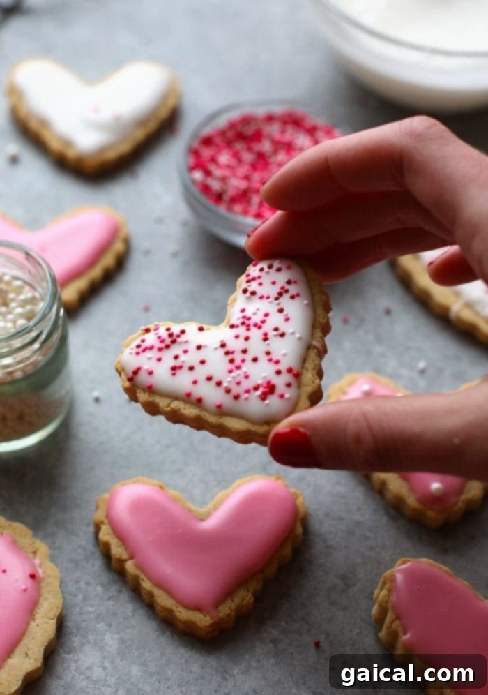 You would seriously never know these are HEALTHY sugar cookies. Our almond flour sugar cookies are made with 8 simple ingredients and guess what? There's no white sugar involved! Frosted healthy almond flour sugar cookies with pink icing