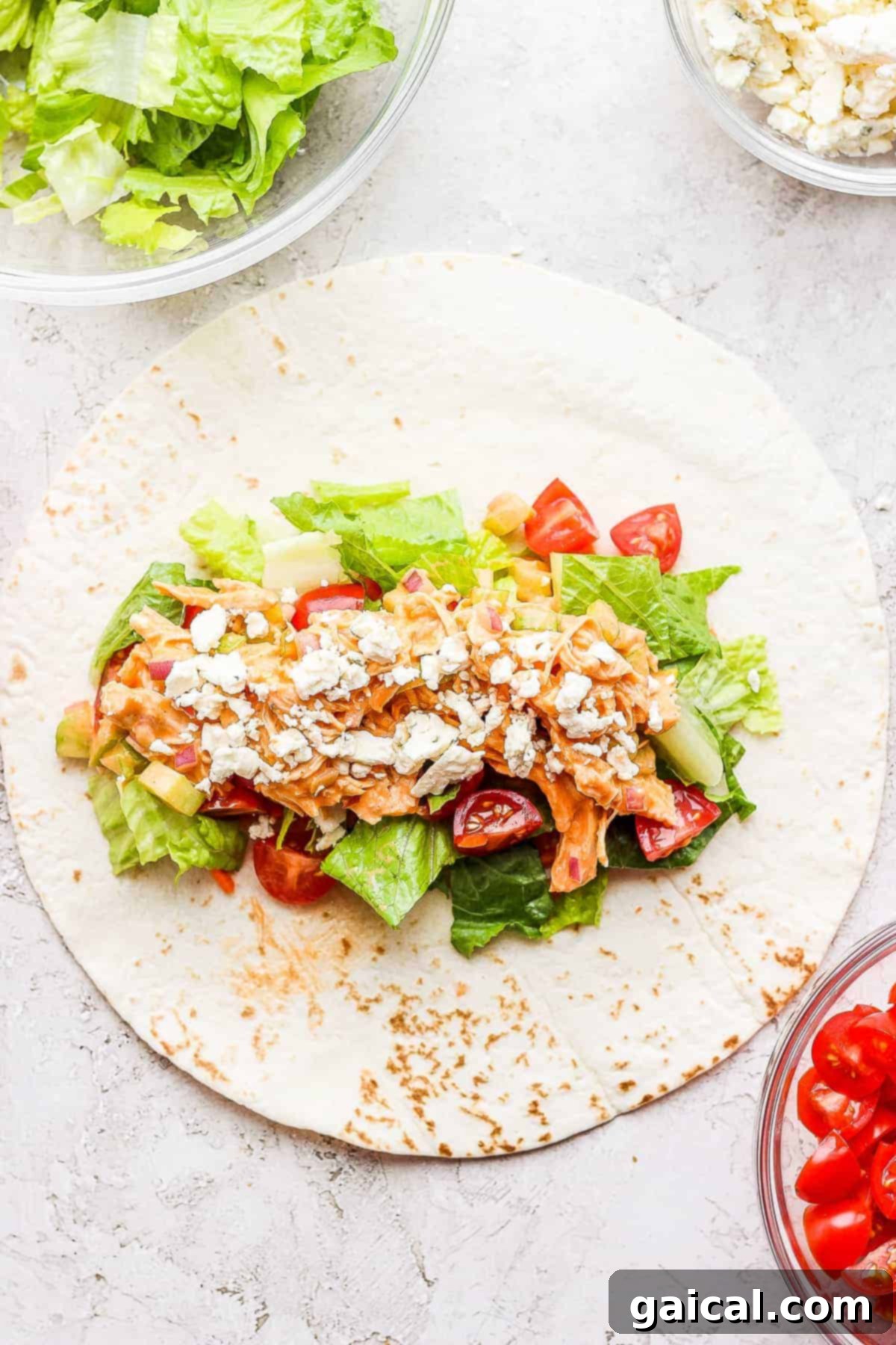 Delicious Buffalo Chicken Wrap A perfectly assembled Buffalo Chicken Wrap, showcasing the rich, colorful filling of buffalo chicken, fresh vegetables, and blue cheese, ready to eat.