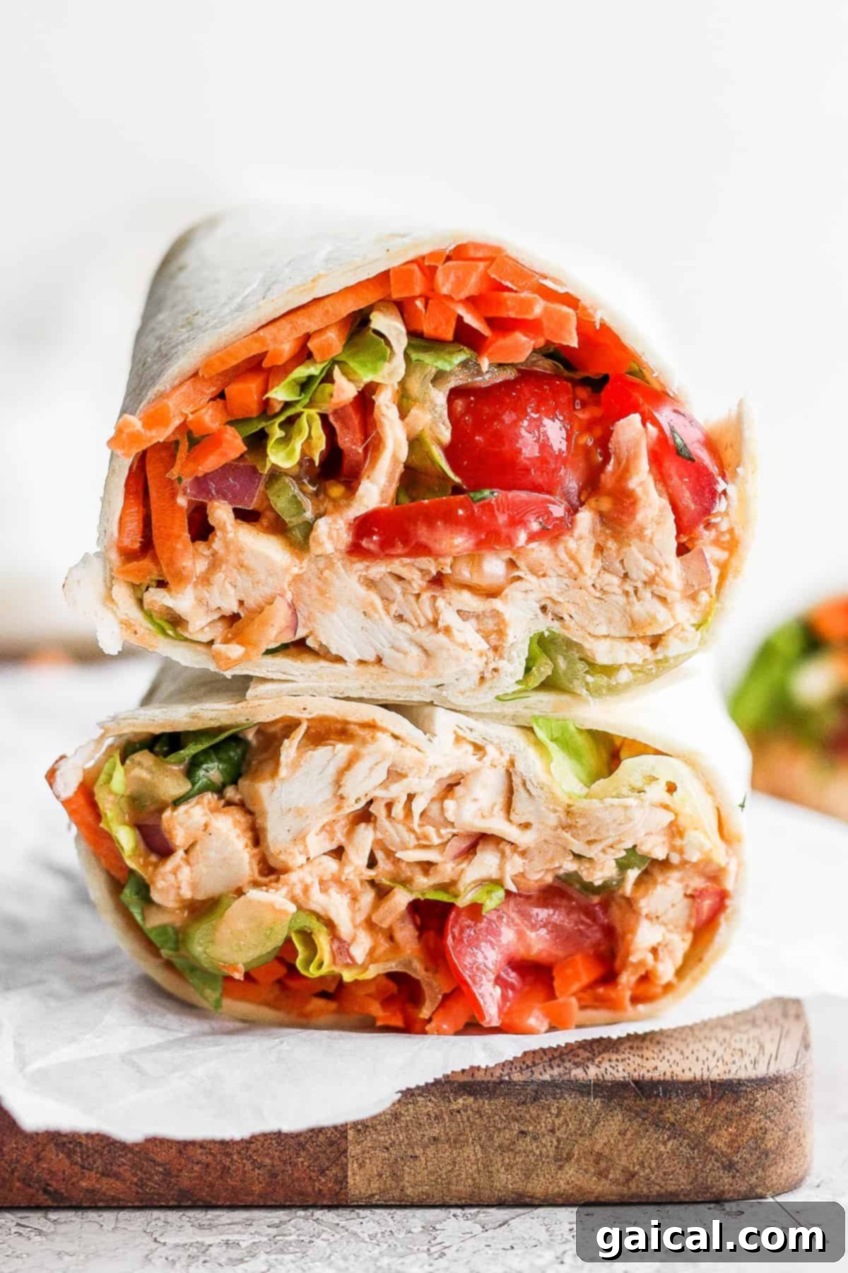 Stacked Buffalo Chicken Wraps A stack of perfectly rolled buffalo chicken wraps, with the vibrant fillings visible, showcasing a delicious and healthy meal prep option.