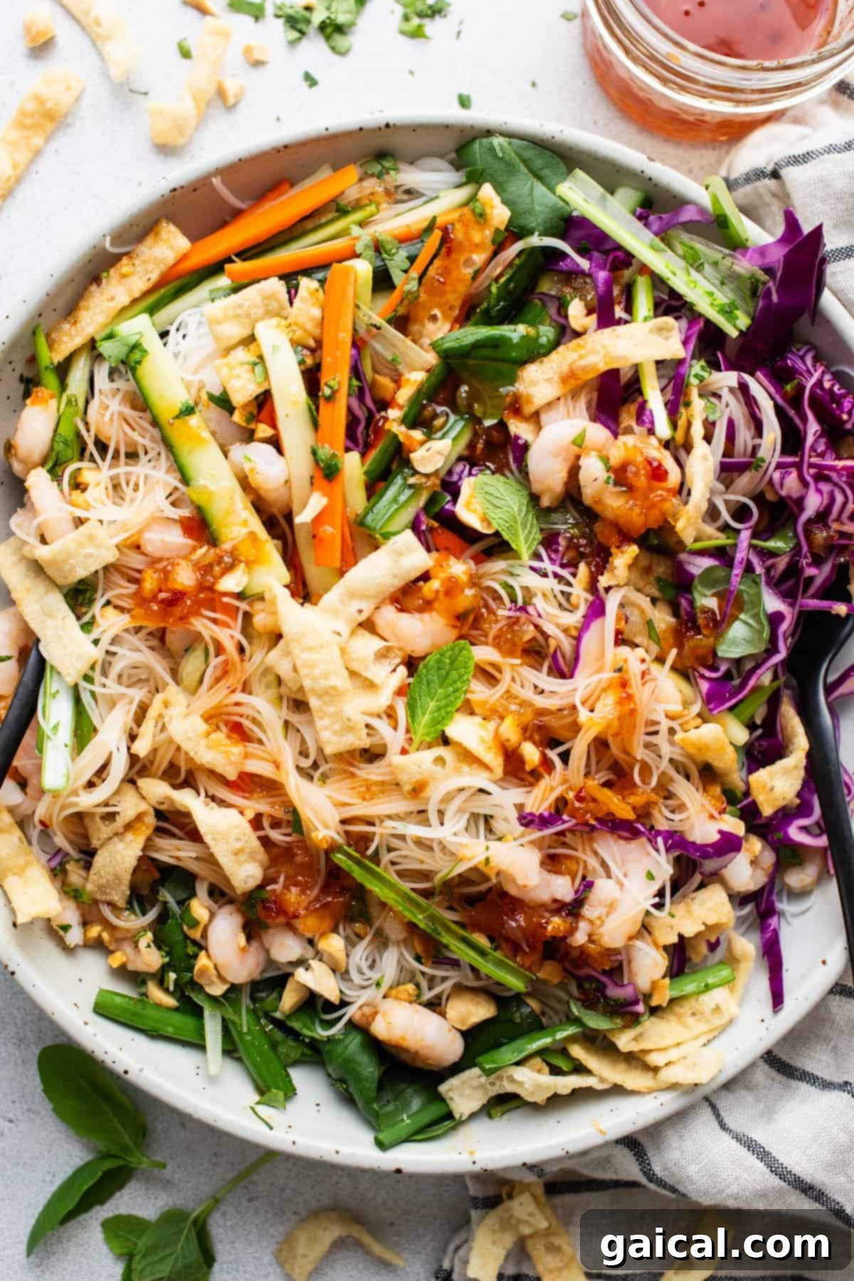 Fresh Spring Roll Bowl 2 A vibrant and generously sized bowl of Asian noodle salad, brimming with colorful vegetables, tender shrimp, and a glistening homemade dressing, signifying a fresh and satisfying meal.