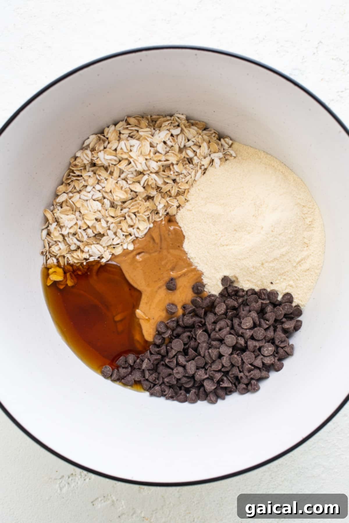 A bowl with ingredients for a chocolate chip cookie.