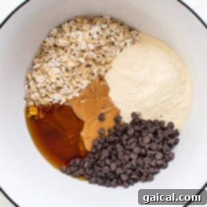 A bowl with ingredients for a chocolate chip cookie.