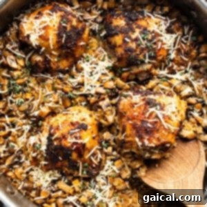 A pan with chicken and mushrooms in it.