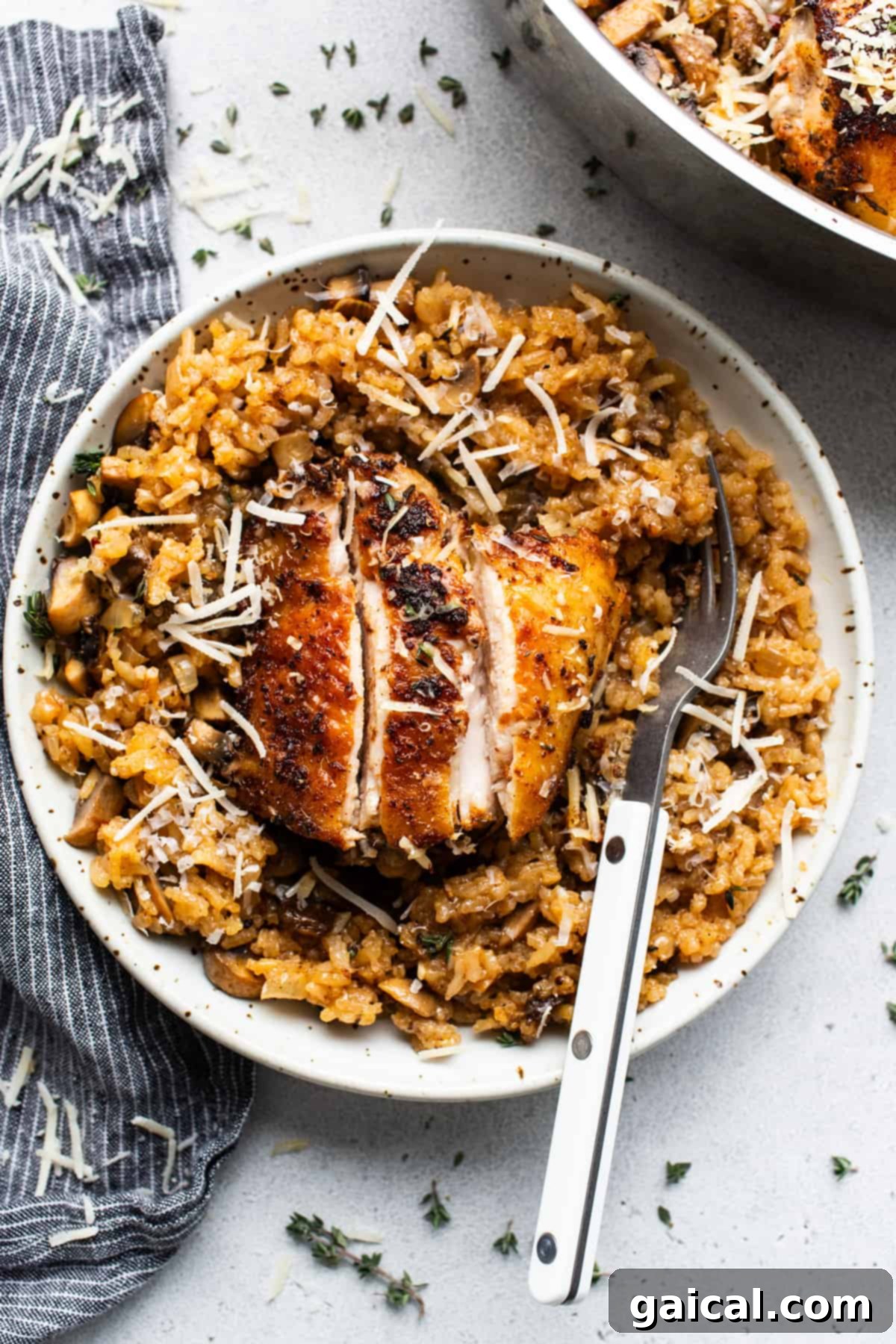Chicken and rice in a white plate with a fork.