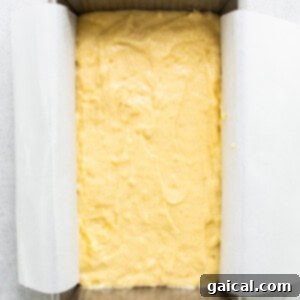 Sun-Kissed Orange Cake 10 A square of yellow cake in a baking pan.