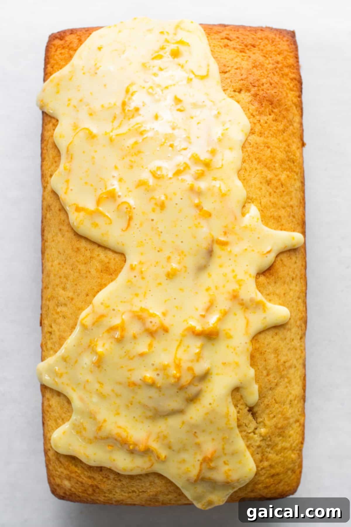 Sun-Kissed Orange Cake 3 A piece of cake with icing on it.