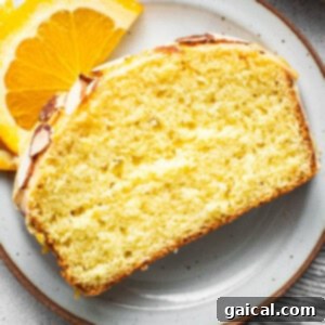 Sun-Kissed Orange Cake 8 A slice of orange pound cake on a plate.