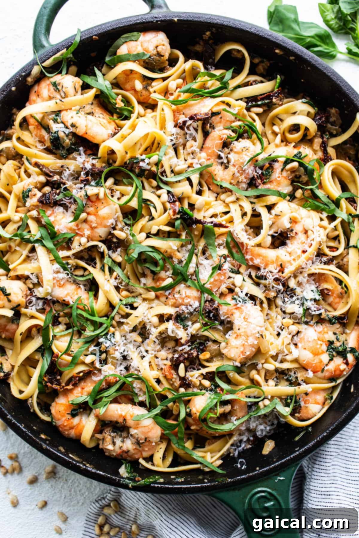 Creamy Tuscan Shrimp Linguini 14 A skillet filled with pasta and shrimp.