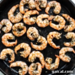 Creamy Tuscan Shrimp Linguini 6 Grilled shrimp cooking in a skillet with herbs.